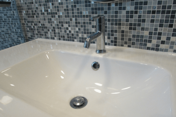 Sink with a chrome, single handle faucet