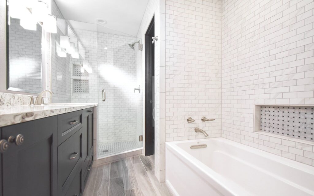 Remodeled bathroom with vanity shower and alcove bath tub