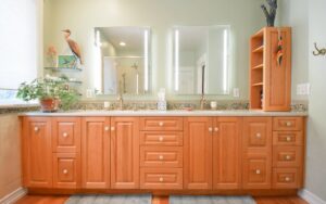 Remodeled bathroom with long wood vanity and double sinks
