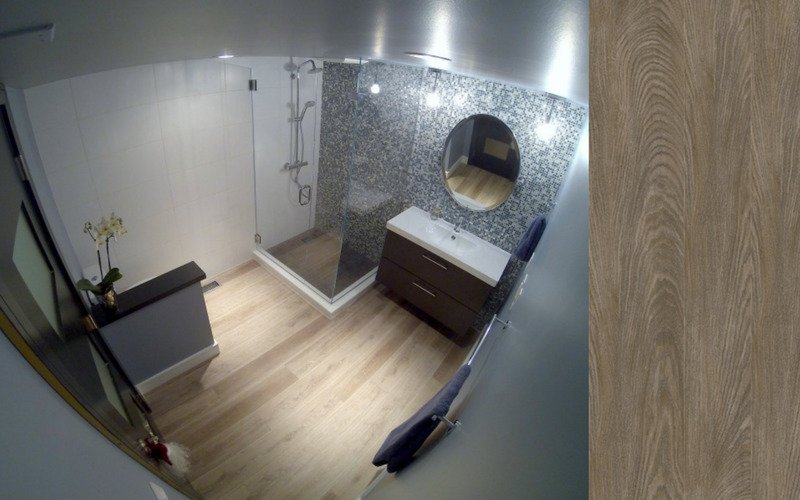 Grey bathroom with light colored wood flooring 