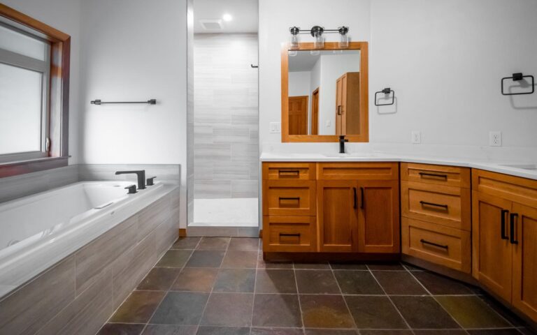 remodeled craftsman master bathroom with drop in tub and wood vanity